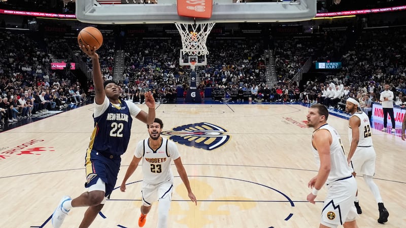 New Orleans Pelicans center Derik Queen (22) goes to the basket against Denver Nuggets forward...