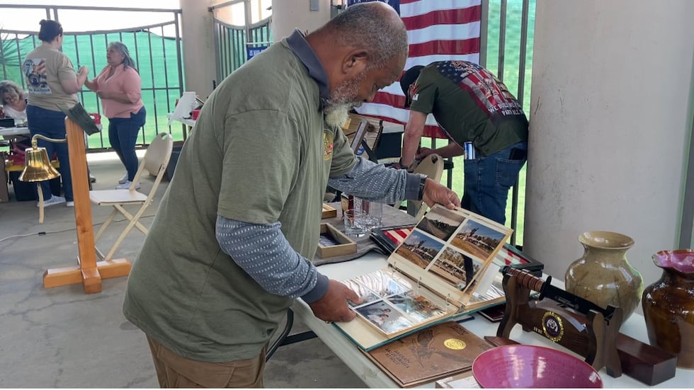 Jeffrey Robinson turned the pages of photo albums from his deployment overseas, with each...