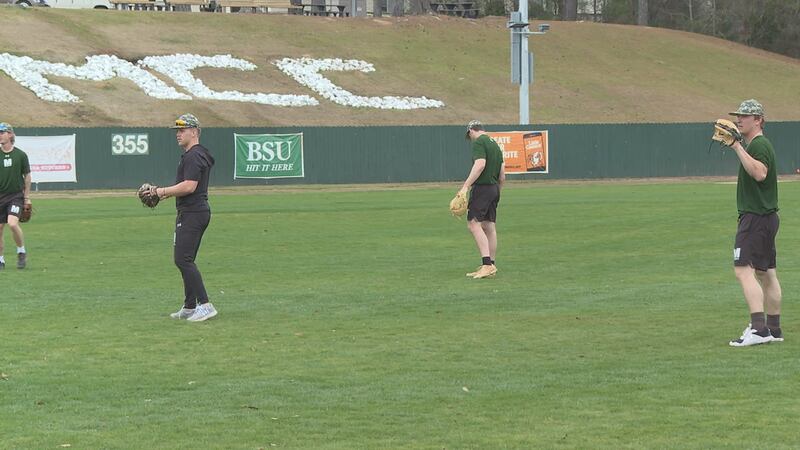 Players from MCC's baseball team warm up before practice