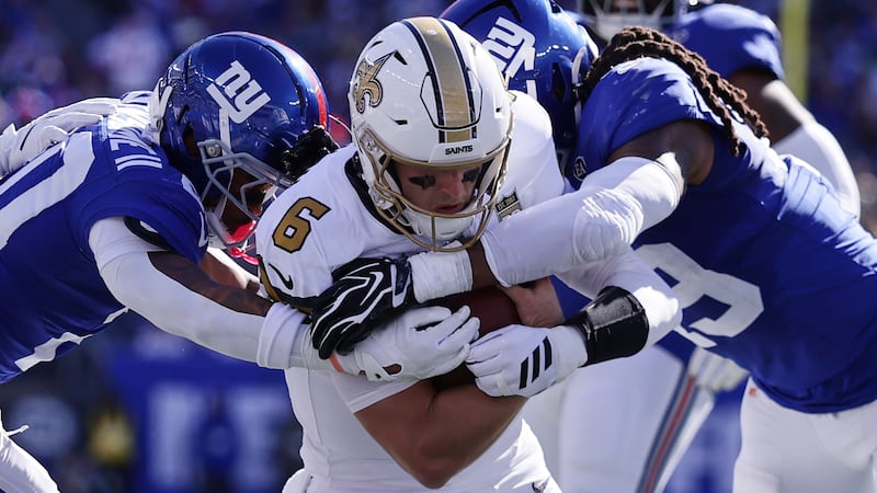 Saints quarterback Tyler Shough, reportedly playing with a broken left hand, is tackled Sunday...