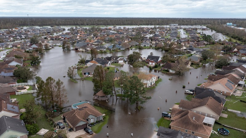 FILE - Flooded streets and homes are shown in the Spring Meadow subdivision in LaPlace, La.,...