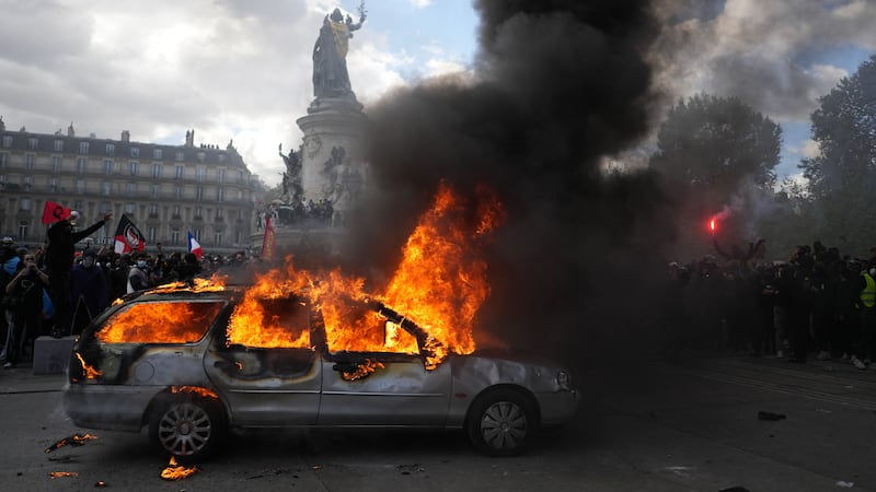 A car burns at Paris' Republique square Saturday (Oct. 17), during a protest ostensibly...